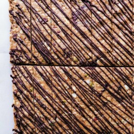 Gorgeous no-bake granola bars with chocolate drizzled over the top.