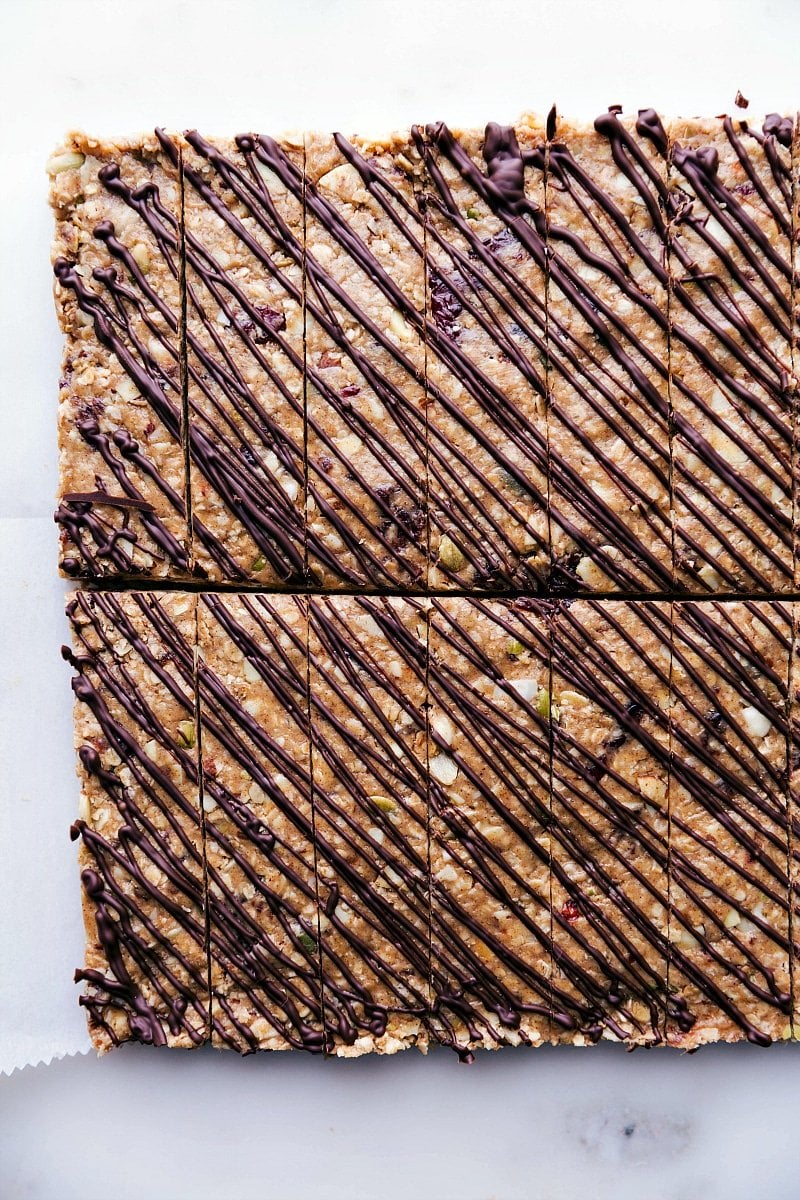 Gorgeous no-bake granola bars with chocolate drizzled over the top.