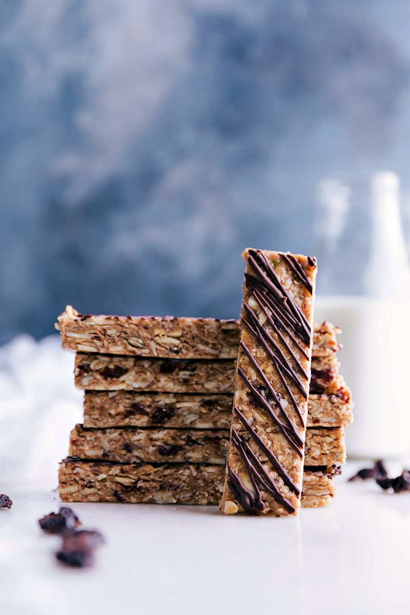 Stack of delicious no-bake granola bars with one laid on its side.