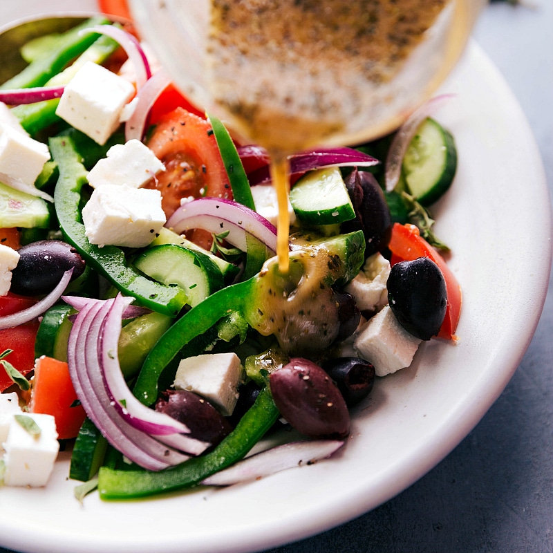 Image of the dressing being poured over salad.