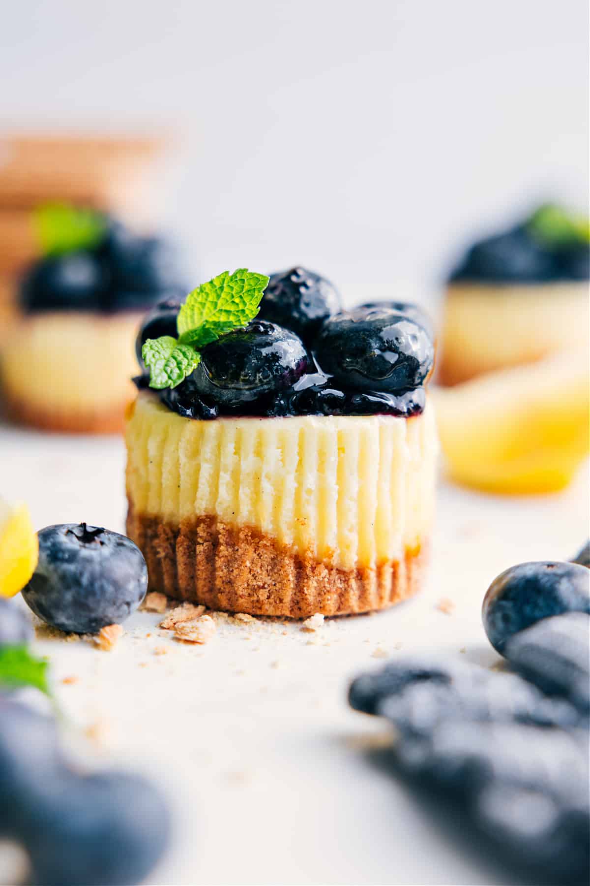 The Most Decadent Dessert With Half The Effort: Mini Blueberry Cheesecakes Mini blueberry cheesecakes topped with fresh mint.