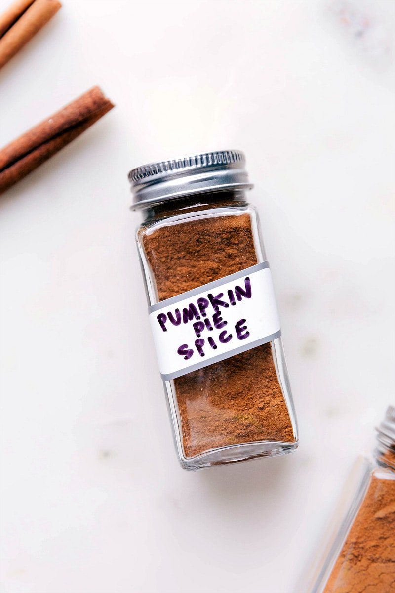 Container of aromatic pumpkin pie spice, a perfect addition to fall recipes.