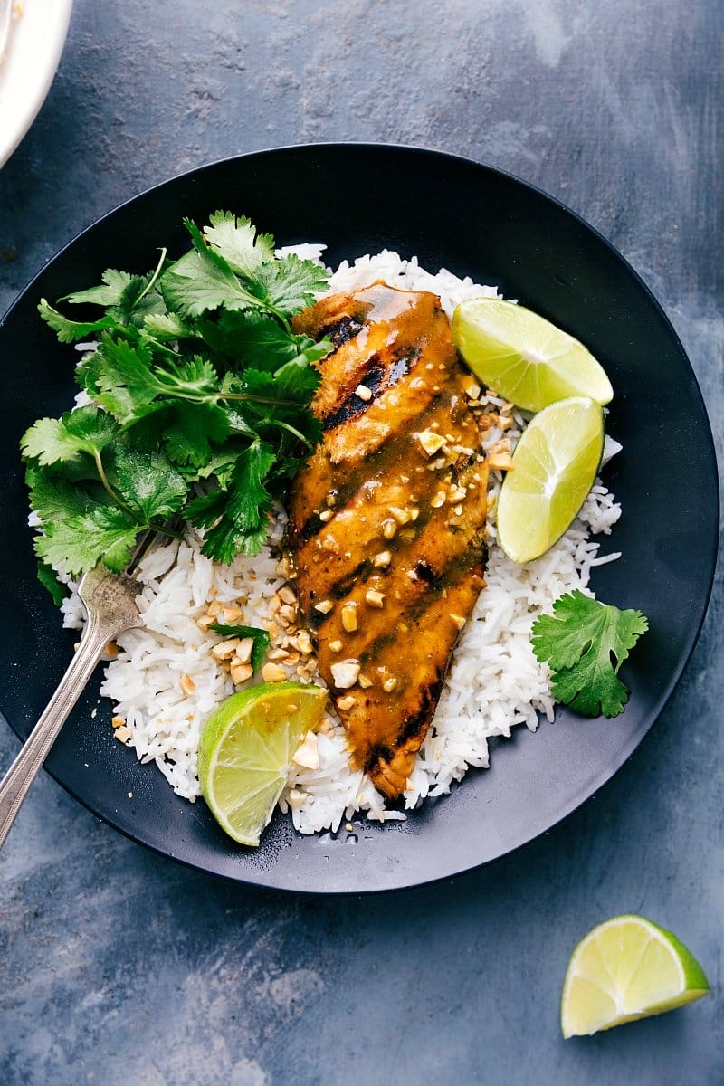 Savory grilled curry chicken atop a bed of fluffy rice, ready to be served.