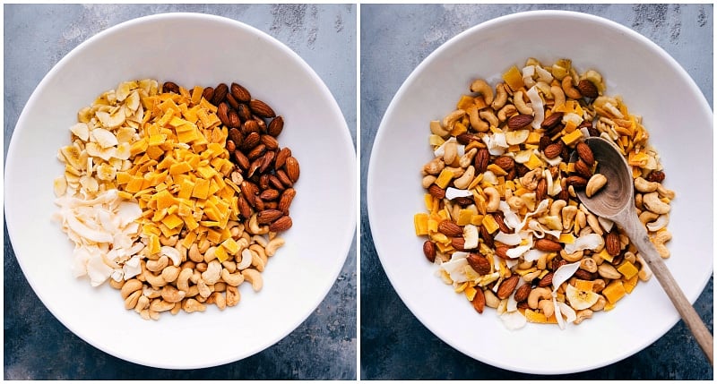 Assorted tropical trail mix ingredients, such as nuts, dried fruits, and coconut shavings, being combined.