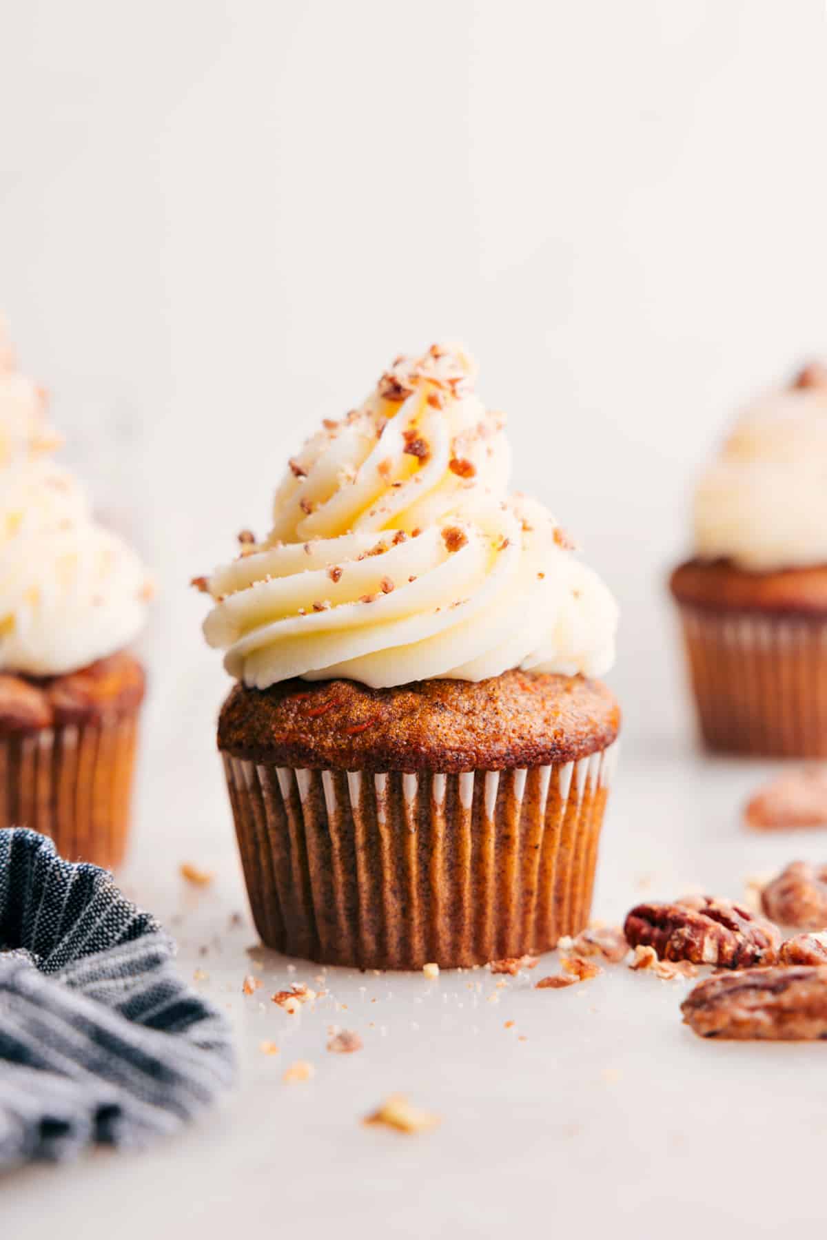 The Best Carrot Cake Cupcakes Carrot Cake Cupcakes with cream cheese frosting on top.