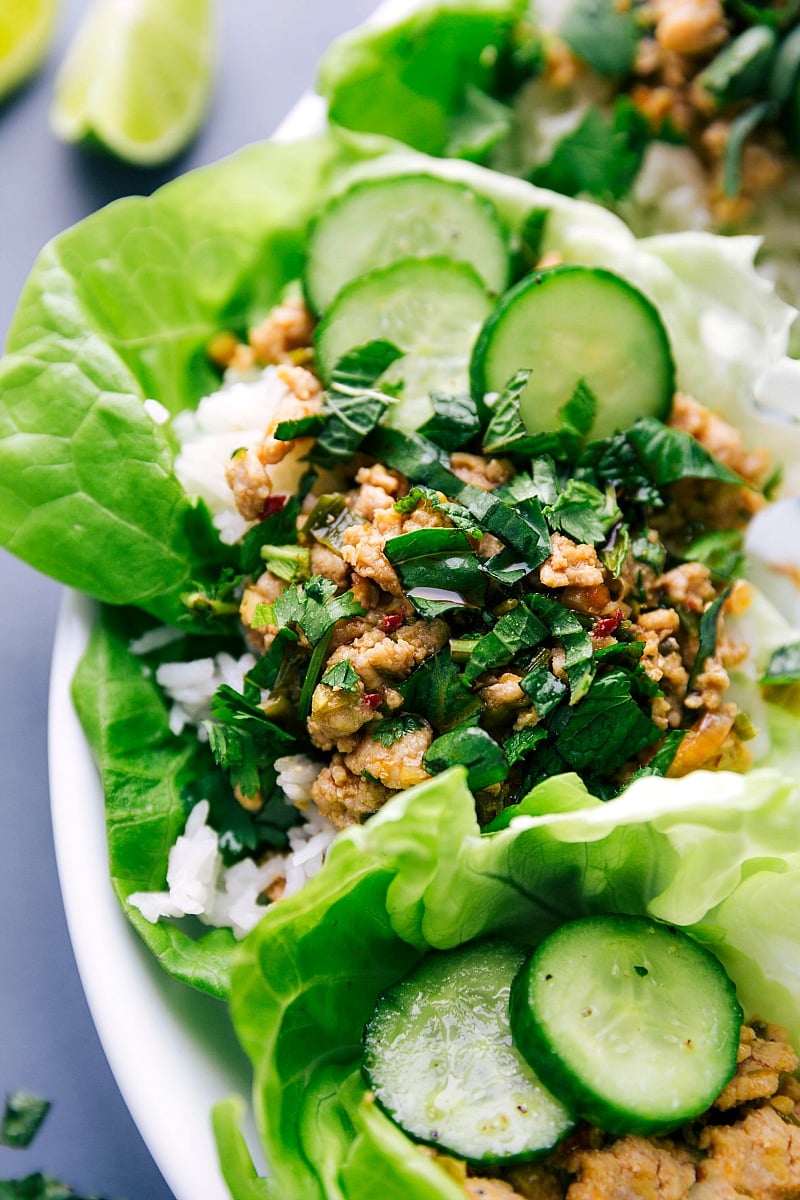 Wrapped chicken larb with fresh vegetables and herbs.