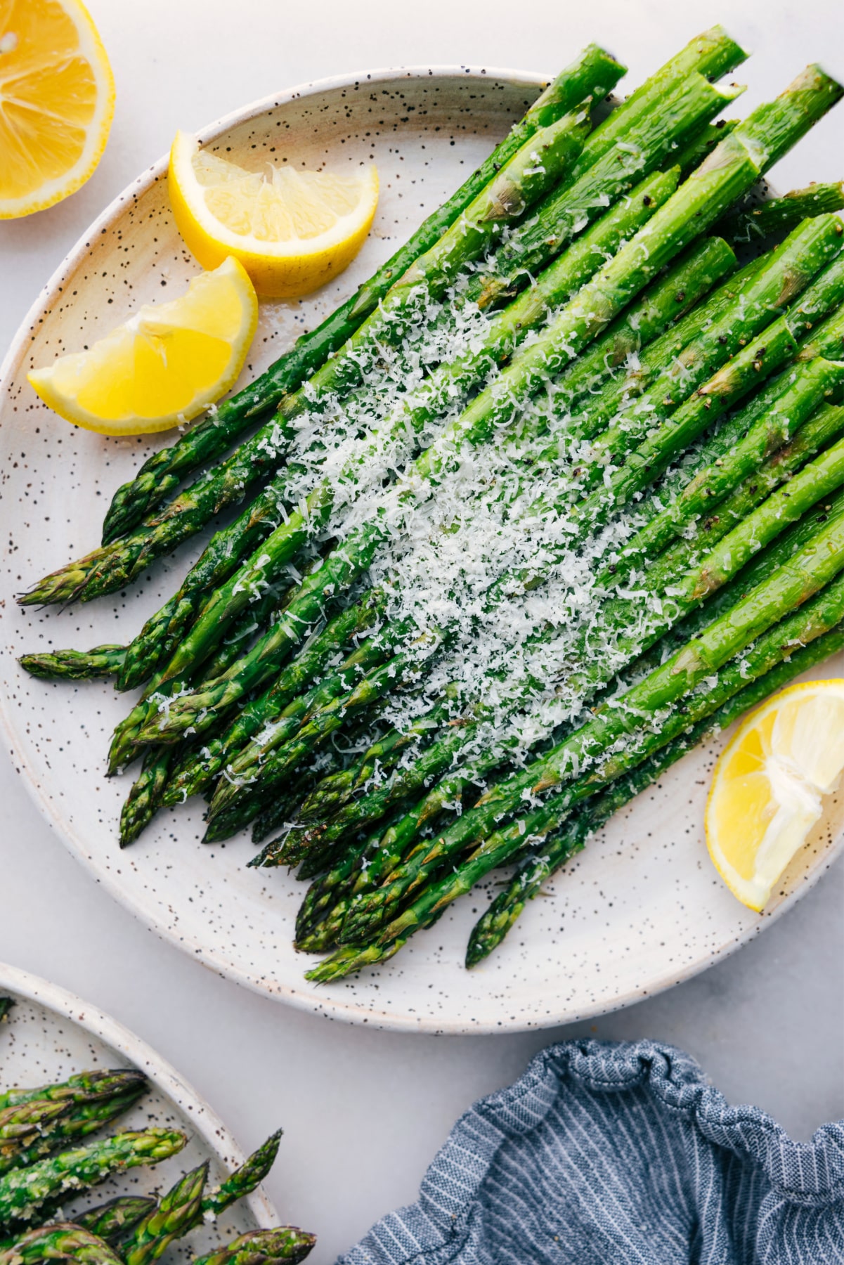 Easy roasted asparagus with fresh parmesan cheese and lemon slices.