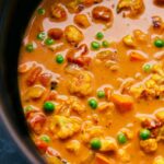 A hearty pot of vegetable curry brimming with colorful vegetables and simmered in a coconut curry broth.