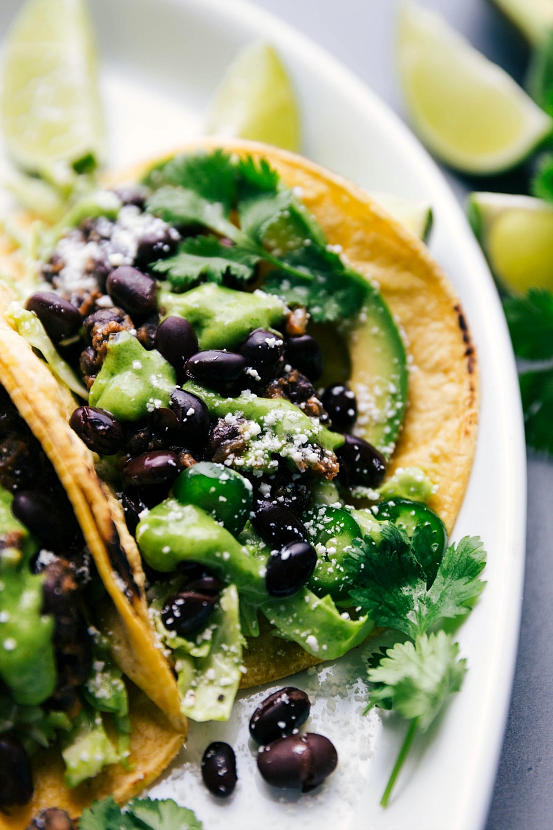 Up-close image of one of Black Bean Tacos with the sauce and fresh cheese and cilantro on top.