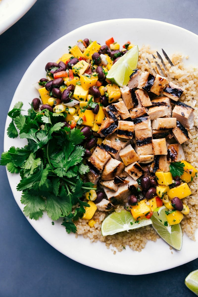 Overhead image of the Chicken Quinoa Bowl with the grilled chicken cut up and the fresh salsa and cilantro on the side.