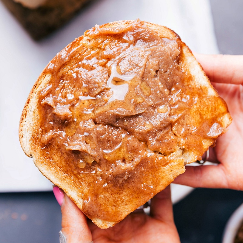 Image of a slice of the Honey Whole Wheat Bread spread with honey butter.