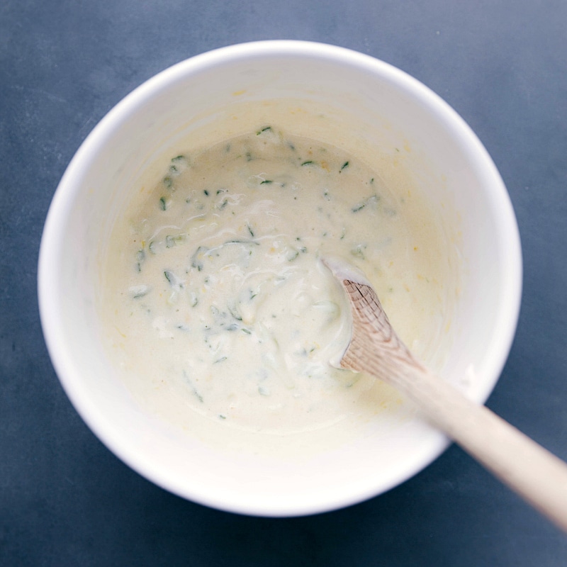 A bowl of delicious and tangy tzatziki sauce, creamy and ready to accompany the recipe.