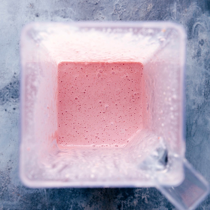 Overhead image of the strawberry milkshake blended up and still in the blender jar.