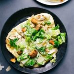 Delicious caesar salad pizza, sliced and ready to enjoy.