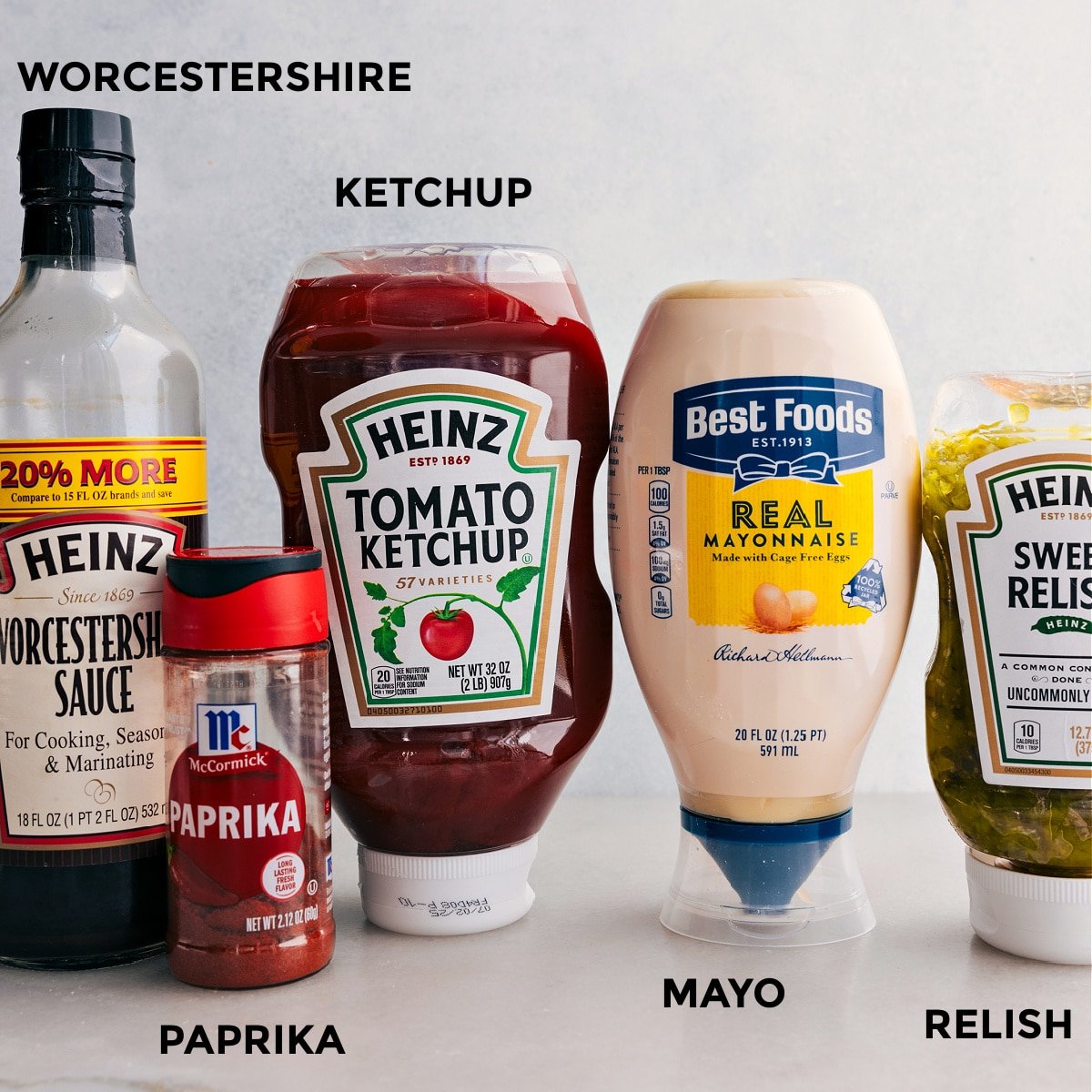 All the ingredients in this recipe including ketchup, mayo, relish, paprika, and Worcestershire sauce prepped out for easy assembly.