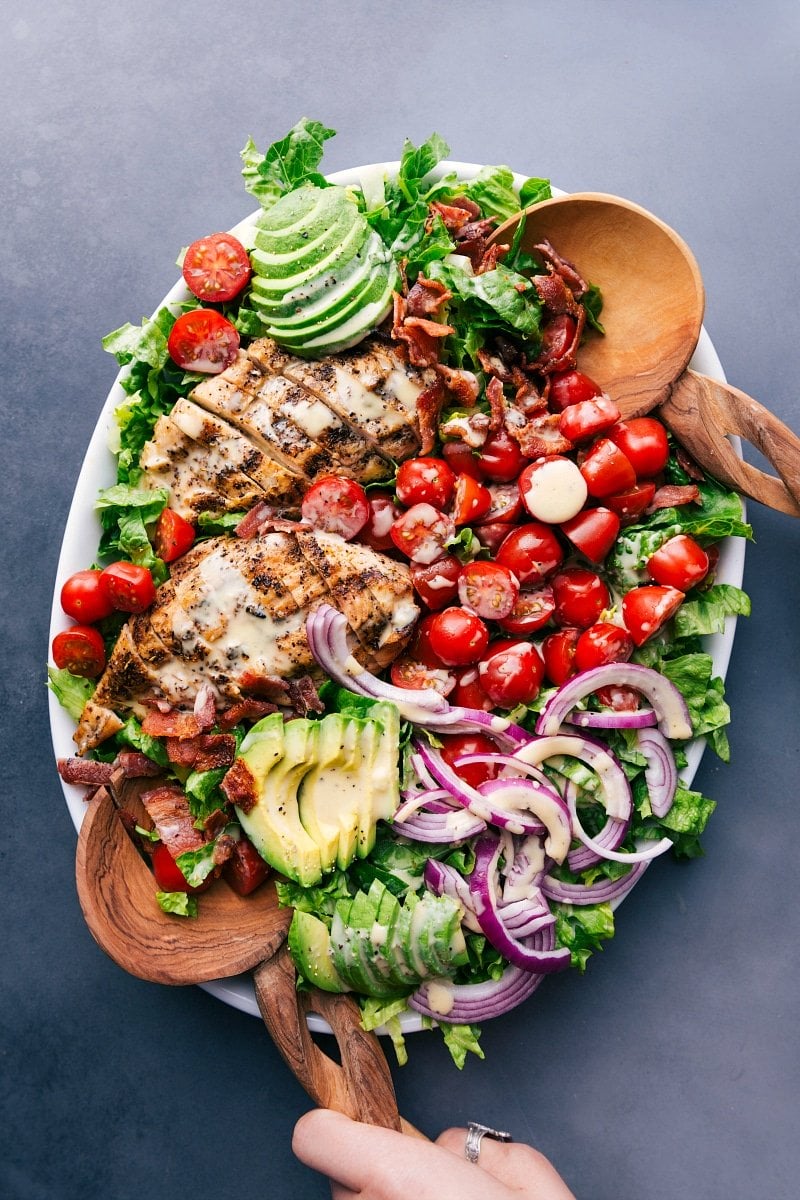 Overhead image of a platter of salad with Honey-Mustard Salad Dressing, ready to be eaten.