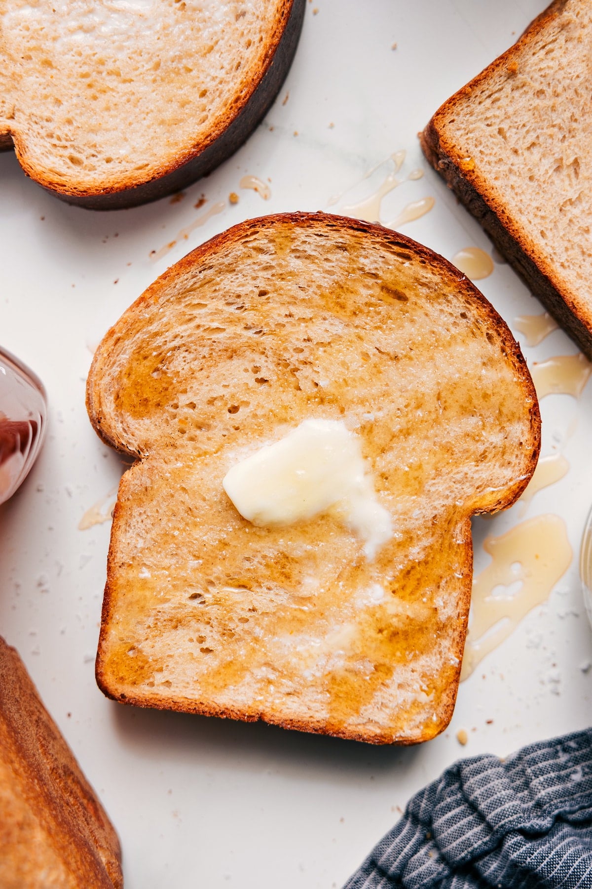 Slice of Honey Whole Wheat Bread topped with melted butter.