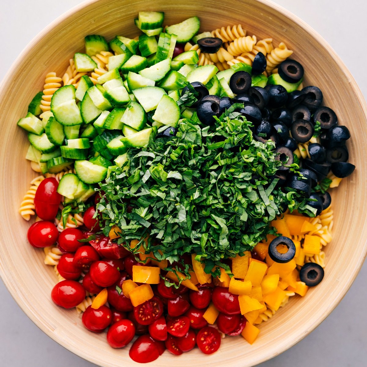 All the ingredients in this Pasta Salad added to a bowl ready to be mixed together.