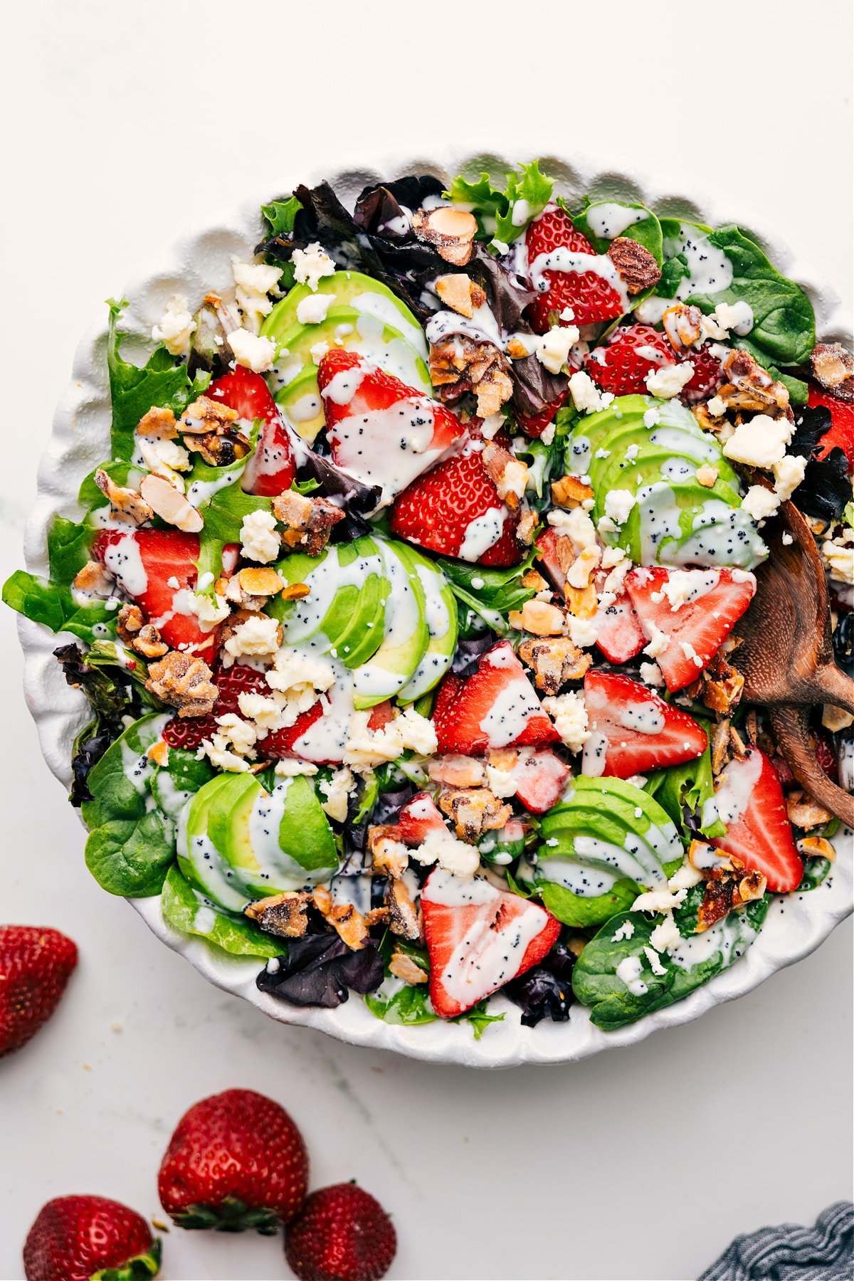 Colorful and Fresh Strawberry Poppy Seed Salad Strawberry Poppyseed Salad tossed in a bowl and drizzled with dressing, ready to enjoy.