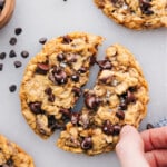 The small batch of chocolate chip cookies with one cookie broken open.