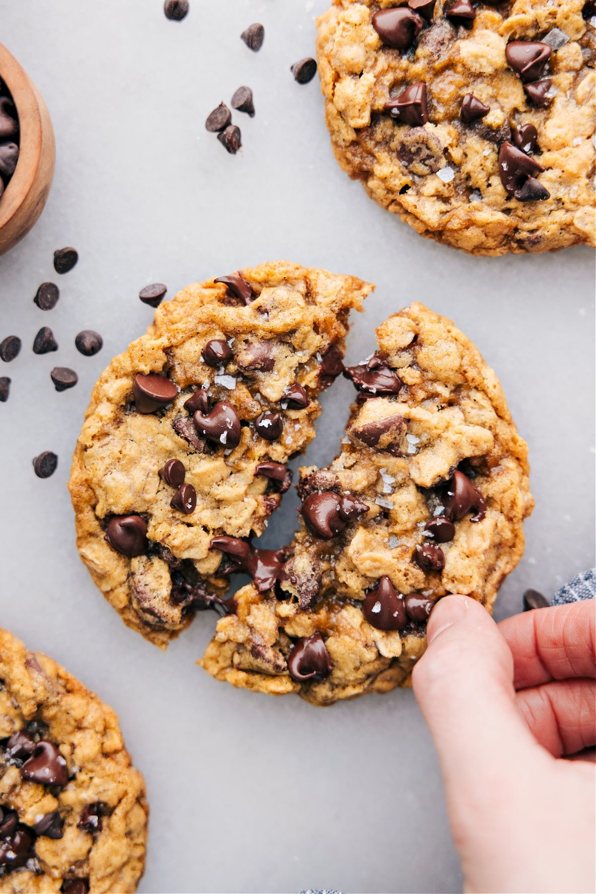 The small batch of chocolate chip cookies with one cookie broken open.