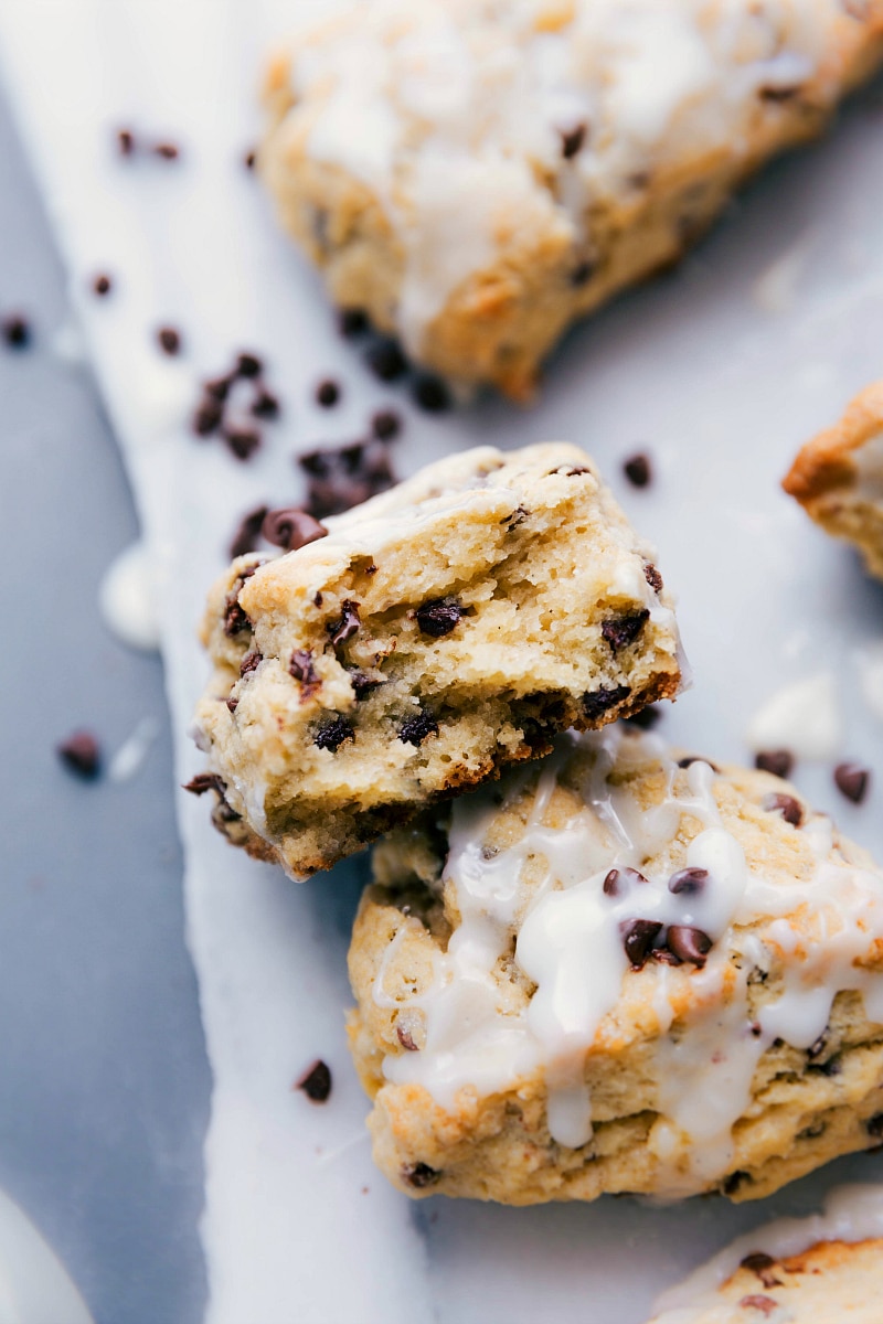 Up-close image of a stack of scones with a bite out of one.