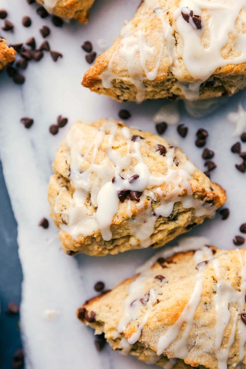 Chocolate chip scones with a luscious glaze and scattered chocolate chips, ready to be devoured.