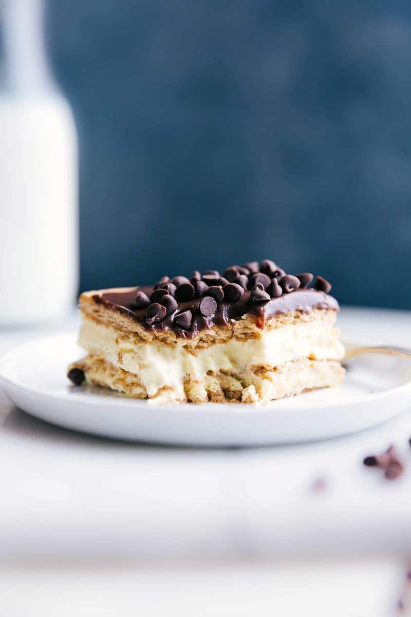 A delicious slice of eclair cake with a bite taken out, revealing its creamy center.