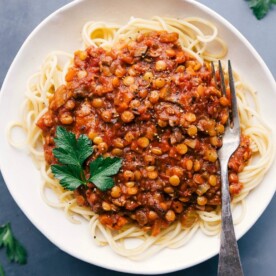 Lentil bolognese served over spaghetti, presenting a savory and mouth-watering meal.