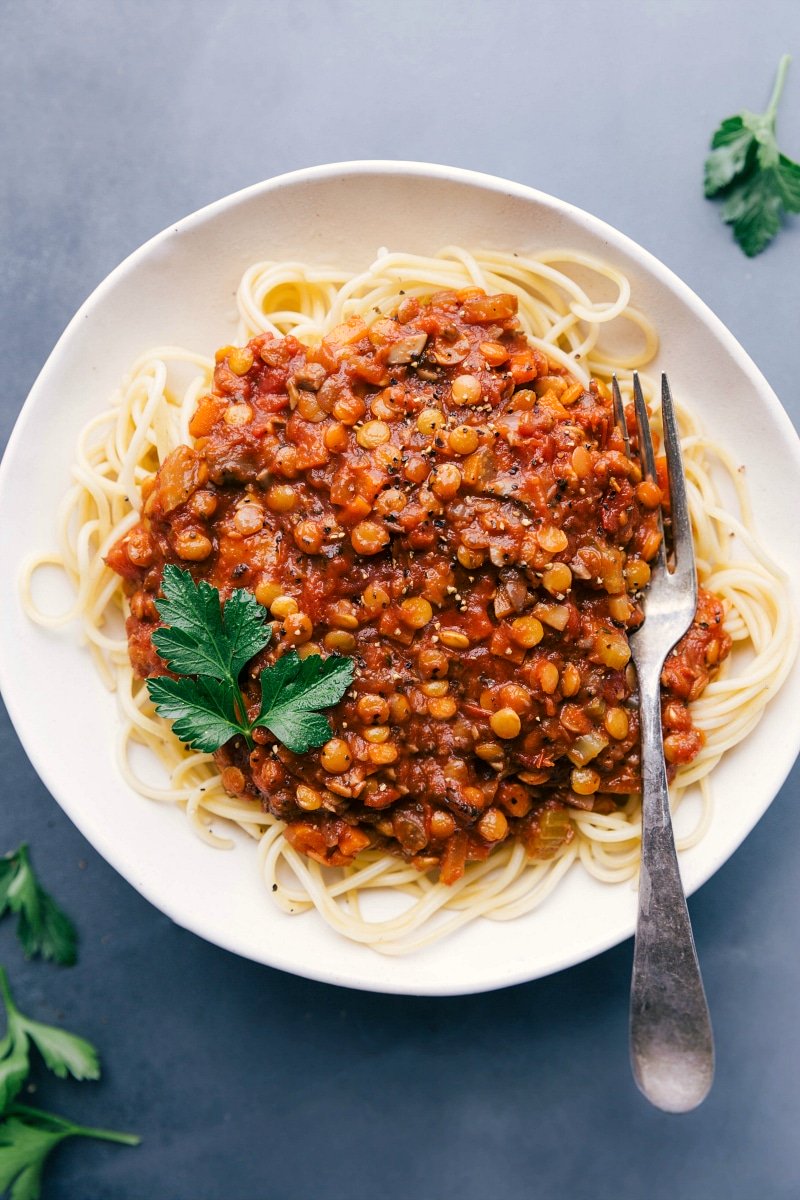 Overhead view of Lentil Bolognese on a bed of spaghetti.