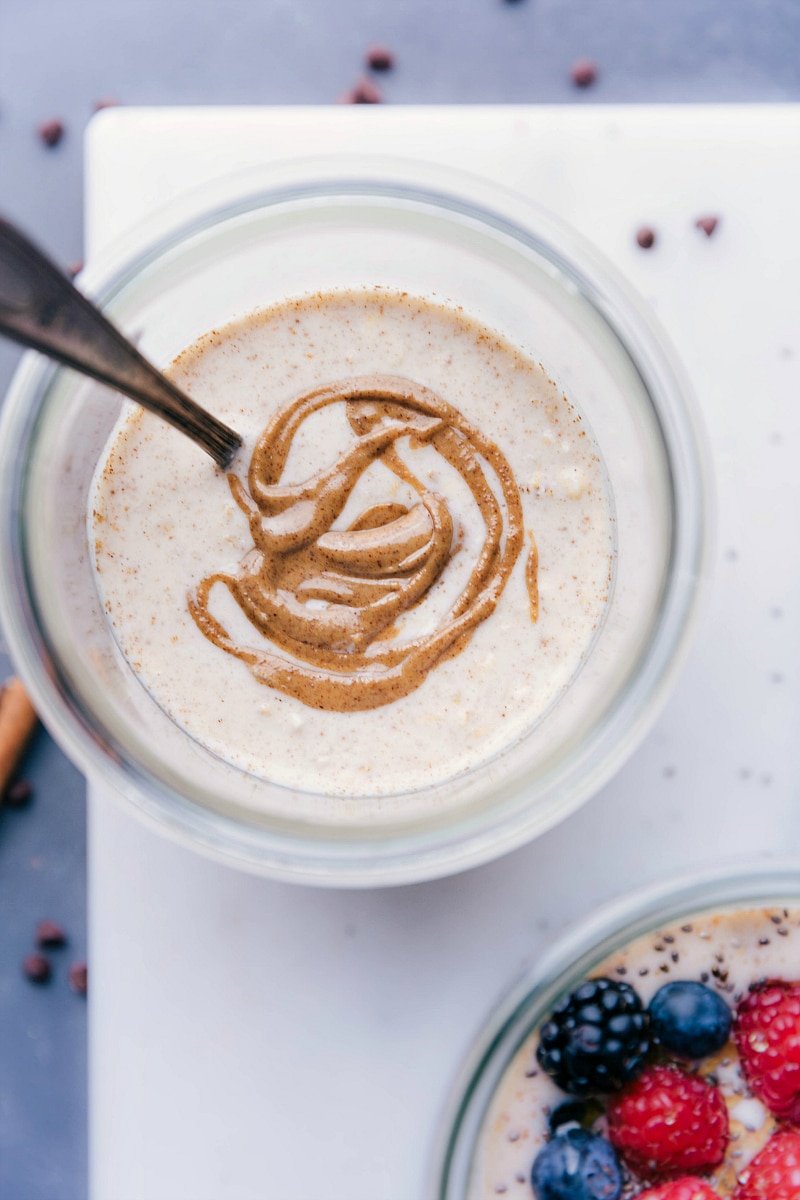 Overhead image of the base recipe for Overnight Oats, with almond butter swirled in it.