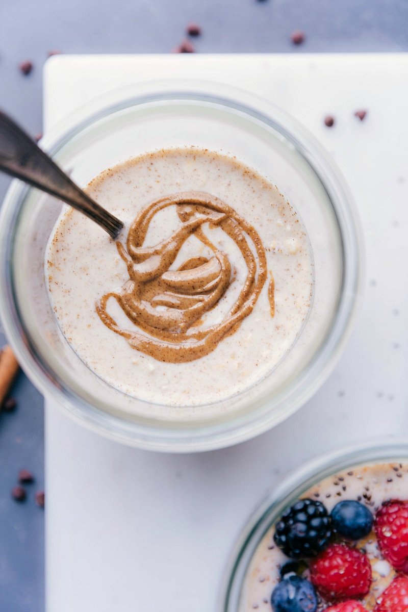 Base recipe for overnight oats in a bowl, with almond butter beautifully swirled into it.