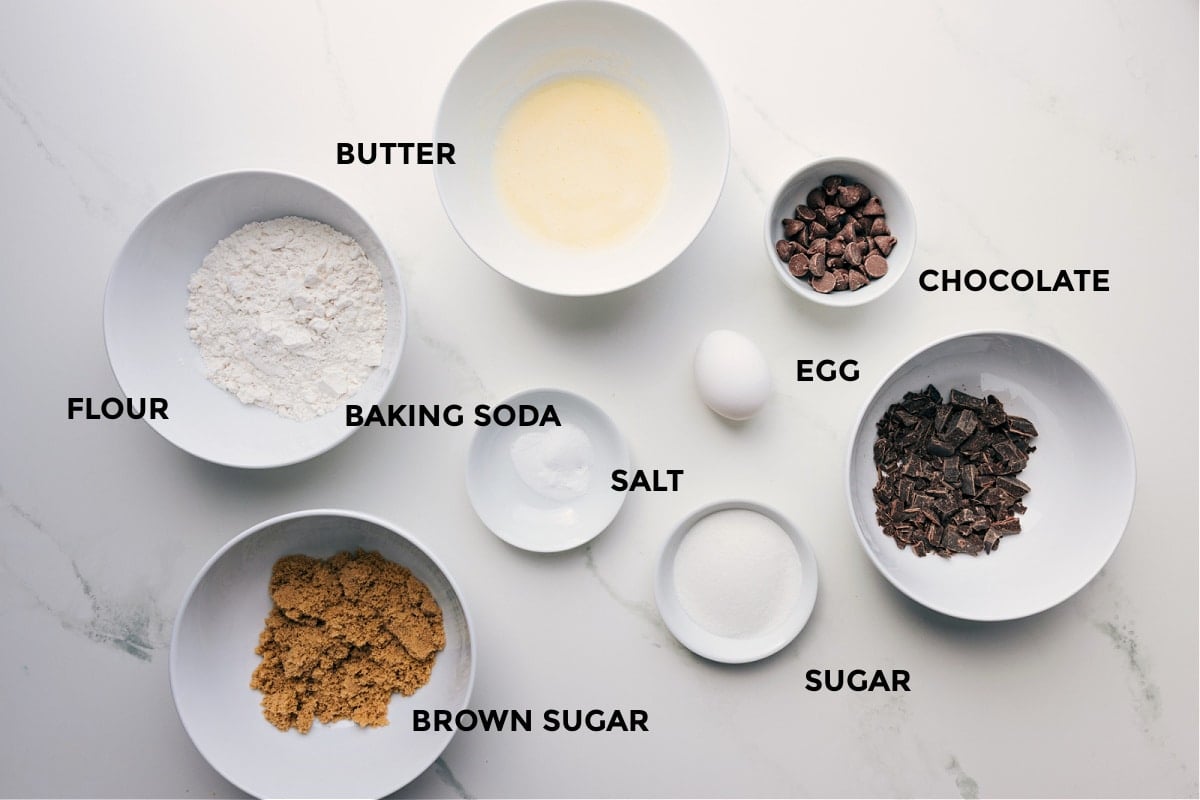 Ingredients prepped for easy assembly, including butter, flour, baking soda, chocolate, egg, sugar, and brown sugar.