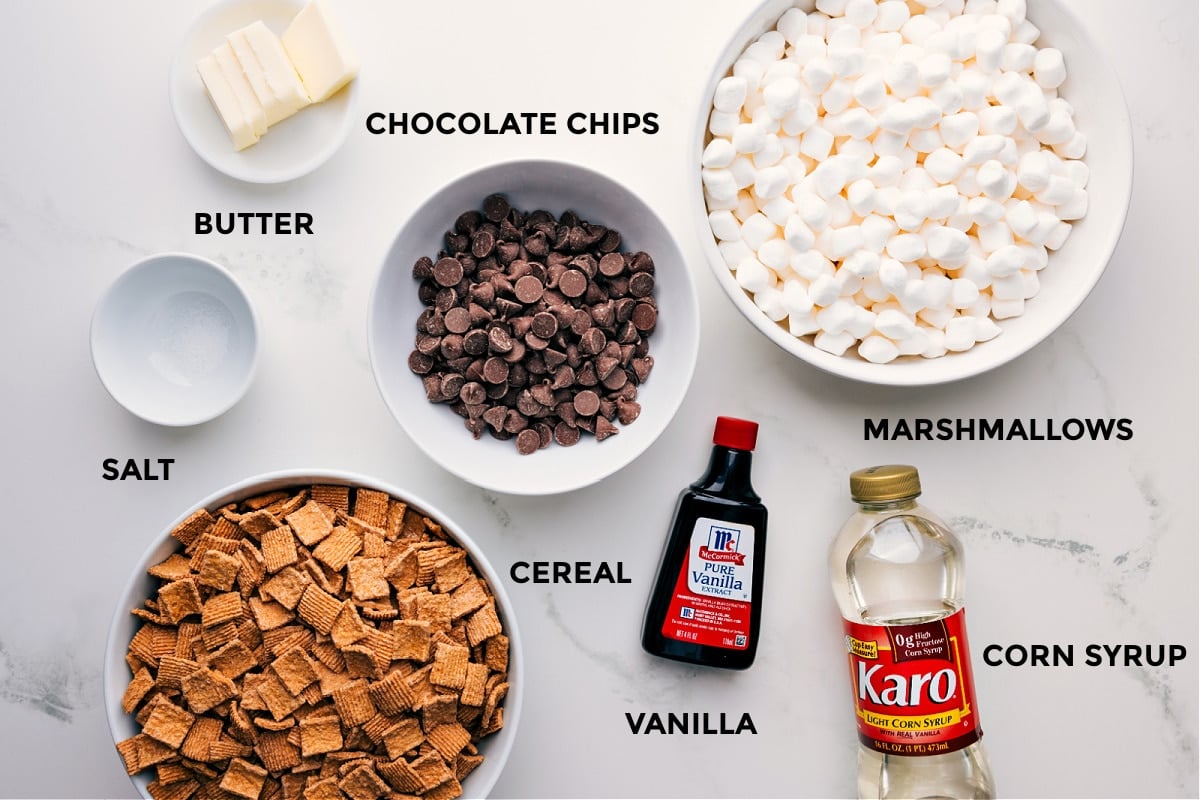All the ingredients for this recipe, including butter, chocolate chips, marshmallows, corn syrup, vanilla, cereal, and salt, prepped and ready for easy assembly.