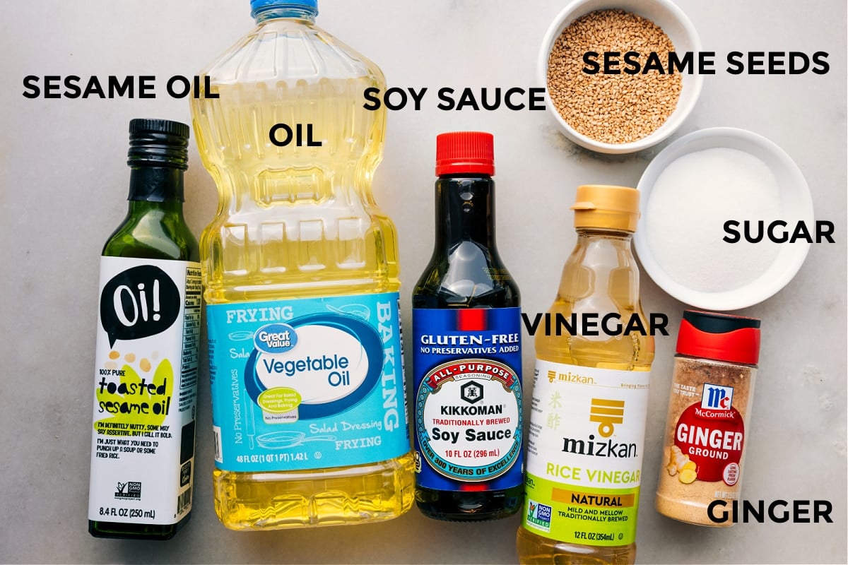 Dressing ingredients prepped and ready: sesame oil, vegetable oil, soy sauce, vinegar, sesame seeds, sugar, and ginger.