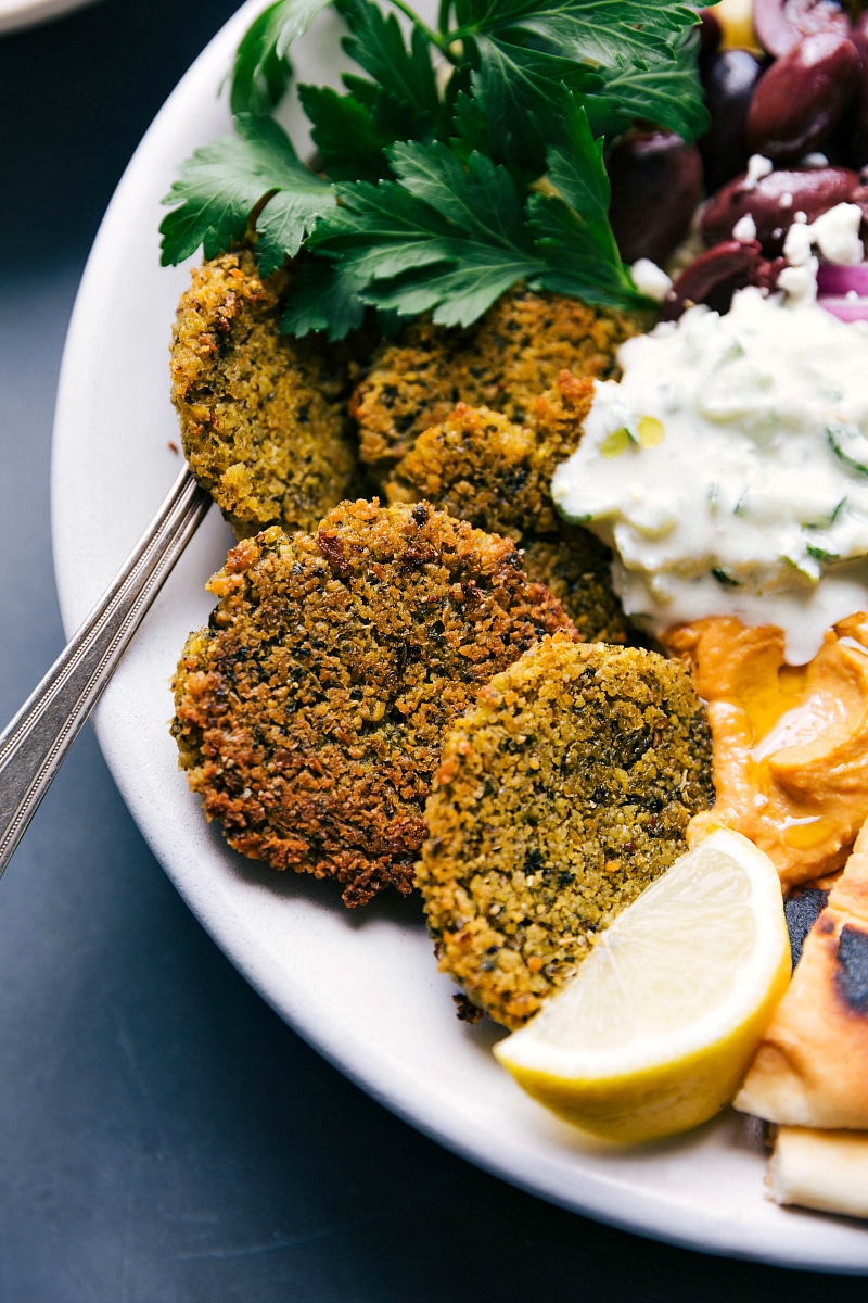 The completed meal with tzatziki sauce, and finished side dishes, ready to be enjoyed.