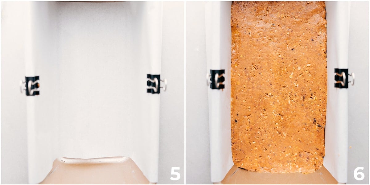 The recipe being pressed into a pan lined with parchment paper.