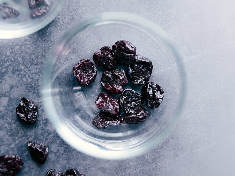 Overhead image of the dried cherries going into the cup for this Tart Cherry Daiquiri Mocktail