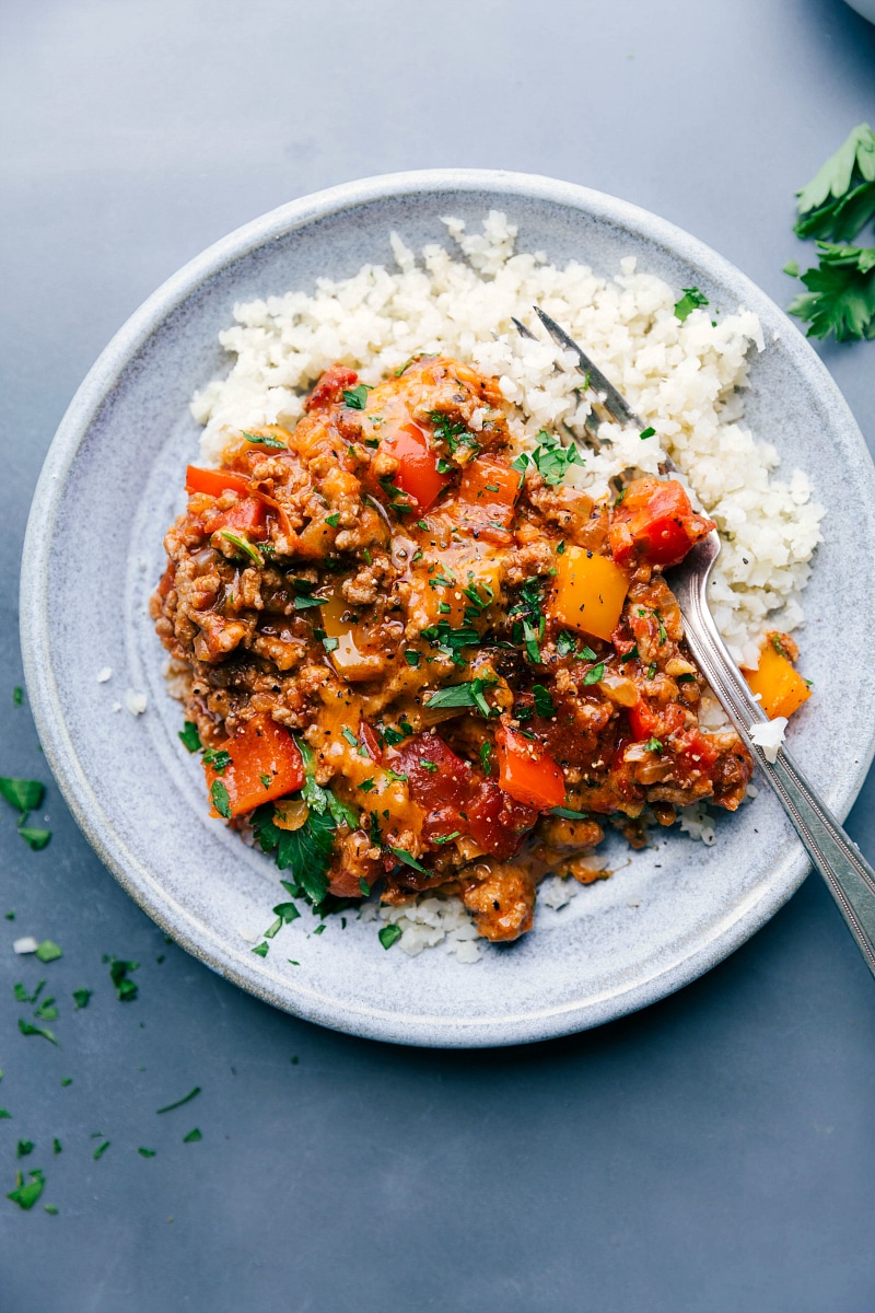 A plate of delicious and savory unstuffed bell peppers served with cauliflower rice alongside.