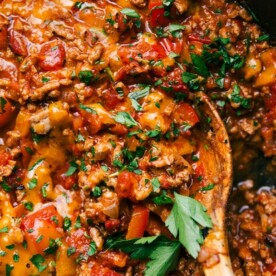 Unstuffed peppers, a pan full of delicious savory ingredients, including meat and peppers, topped with fresh herbs.