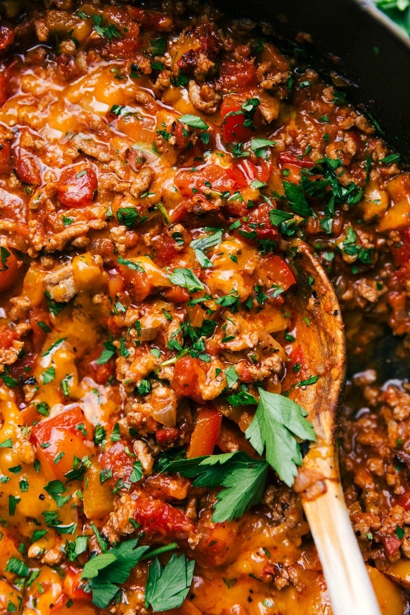 Unstuffed peppers, a pan full of delicious savory ingredients, including meat and peppers, topped with fresh herbs.