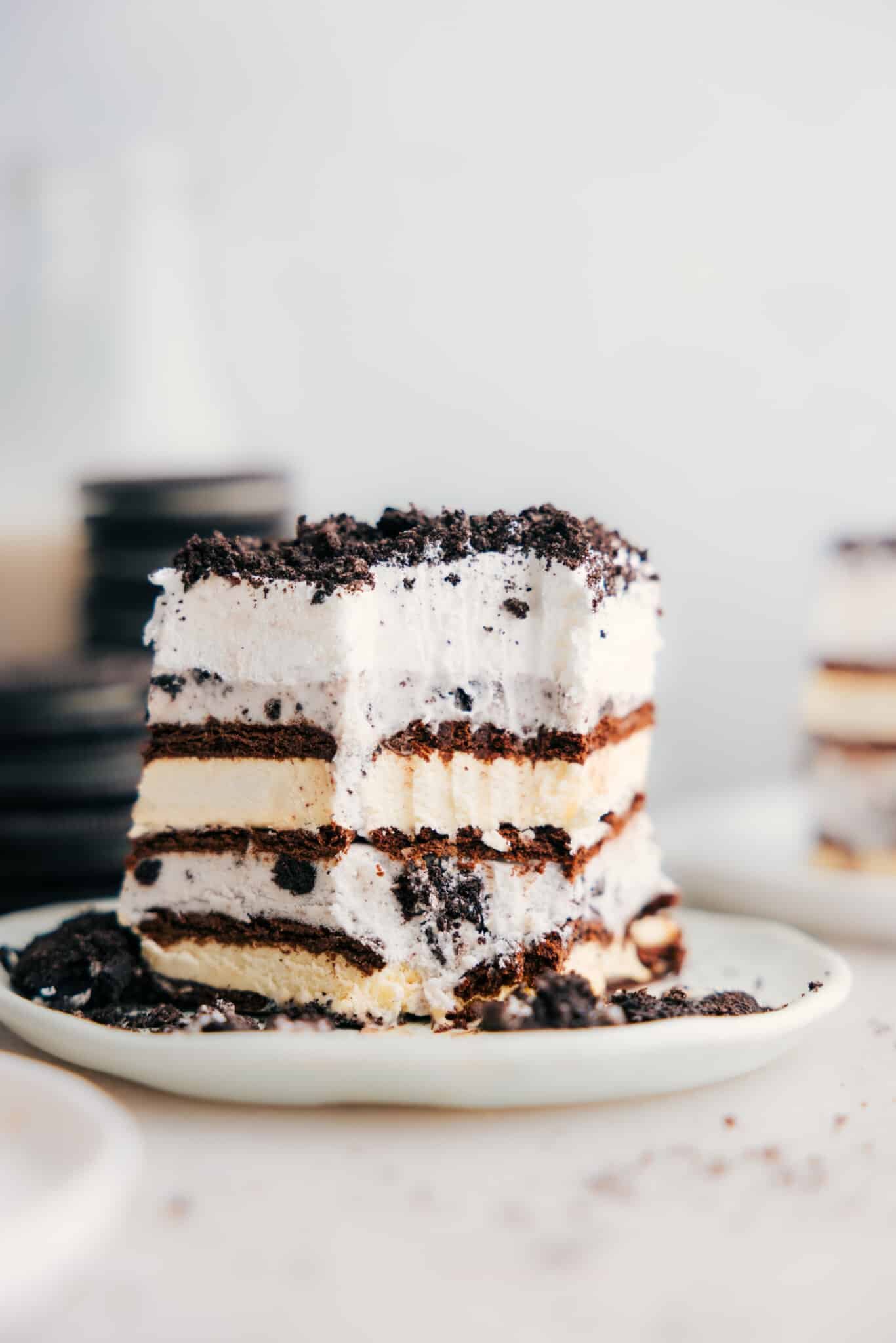 Ice cream sandwich cake with a bite out of it showing all the layers.