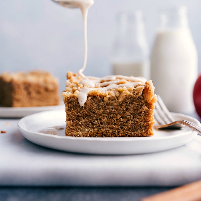 Pouring the delicious glaze over the freshly baked apple coffee cake recipe.