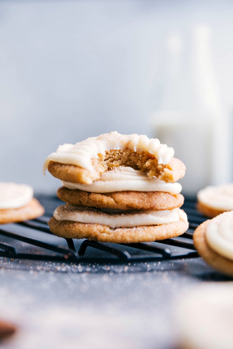 Cinnamon roll cookies stacked neatly, topped with delicious frosting to complement their sweet cinnamon flavor.