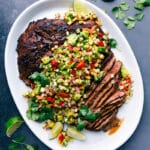Sliced flank steak with corn salsa showing the perfectly cooked interior, creating a deliciously complimentary meal.