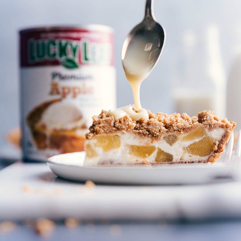 Image of a spoonful of sweetened condensed milk being drizzled over the baked pie.