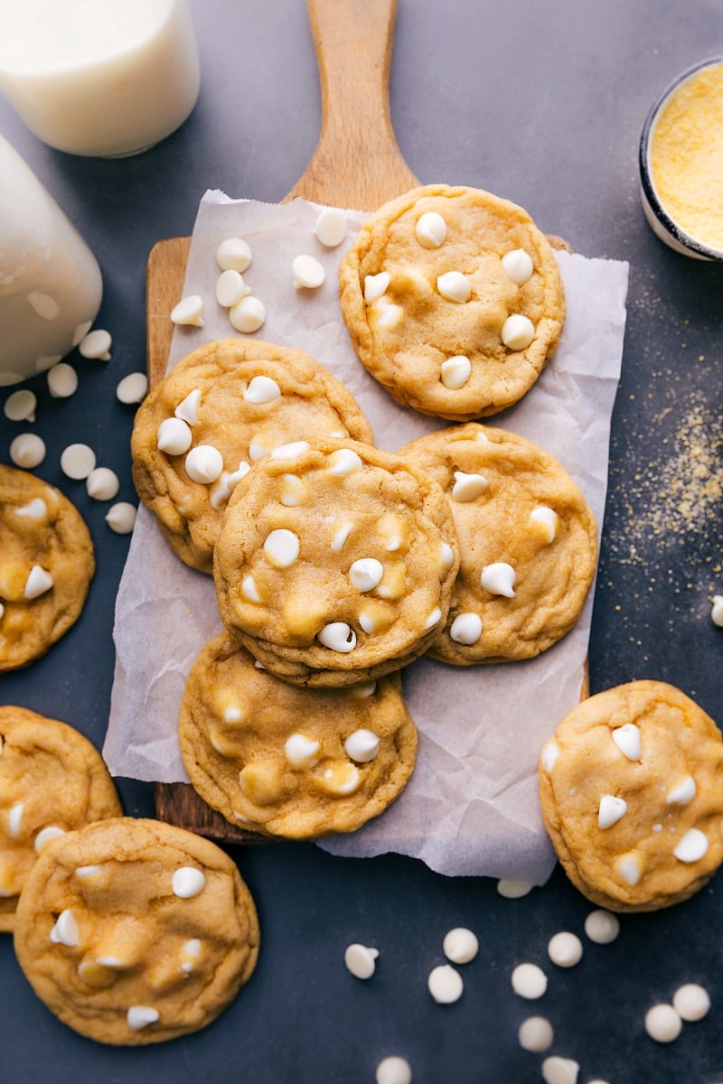 A batch of freshly baked cornmeal cookies, each one topped with white chocolate chips, delicious and flavor-packed.