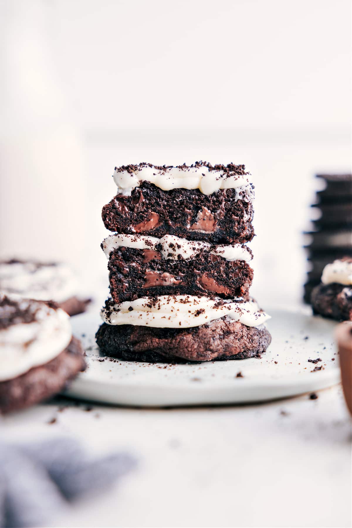 Crumbl Oreo Cookies are a copycat recipe of Crumbl's fan-favorite Oreo cookie recipe! These Oreo-crumb encrusted rich chocolate cookies are loaded with cream cheese frosting and garnished with crushed-up Oreos. Recipe via ChelseasMessyApron #dessert #quick #easy #simple #best #copycat #decadent #frosting #crumbl #oreo #cookies