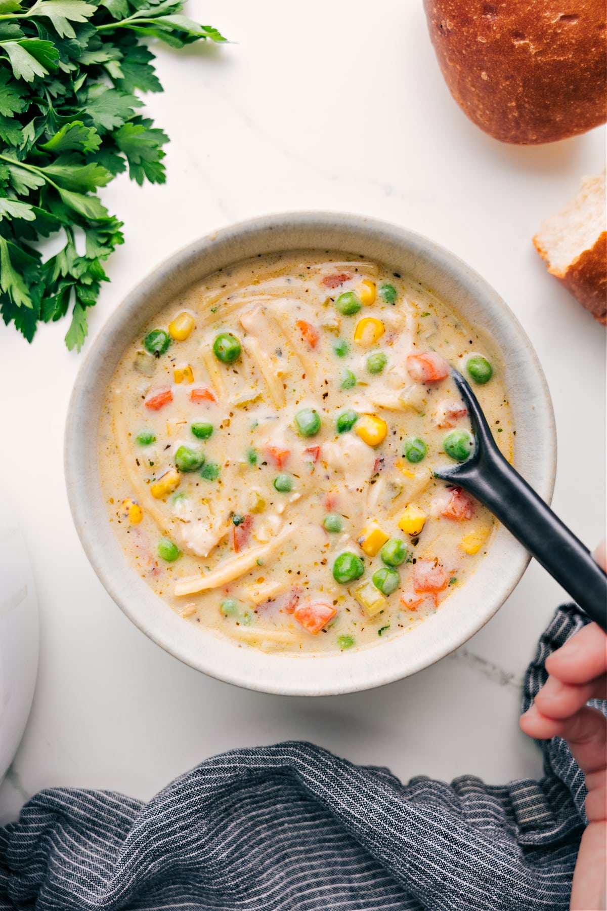 Flavorful Creamy Chicken Noodle Soup with Vegetables Creamy Chicken Noodle Soup in a bowl ready to be enjoyed.