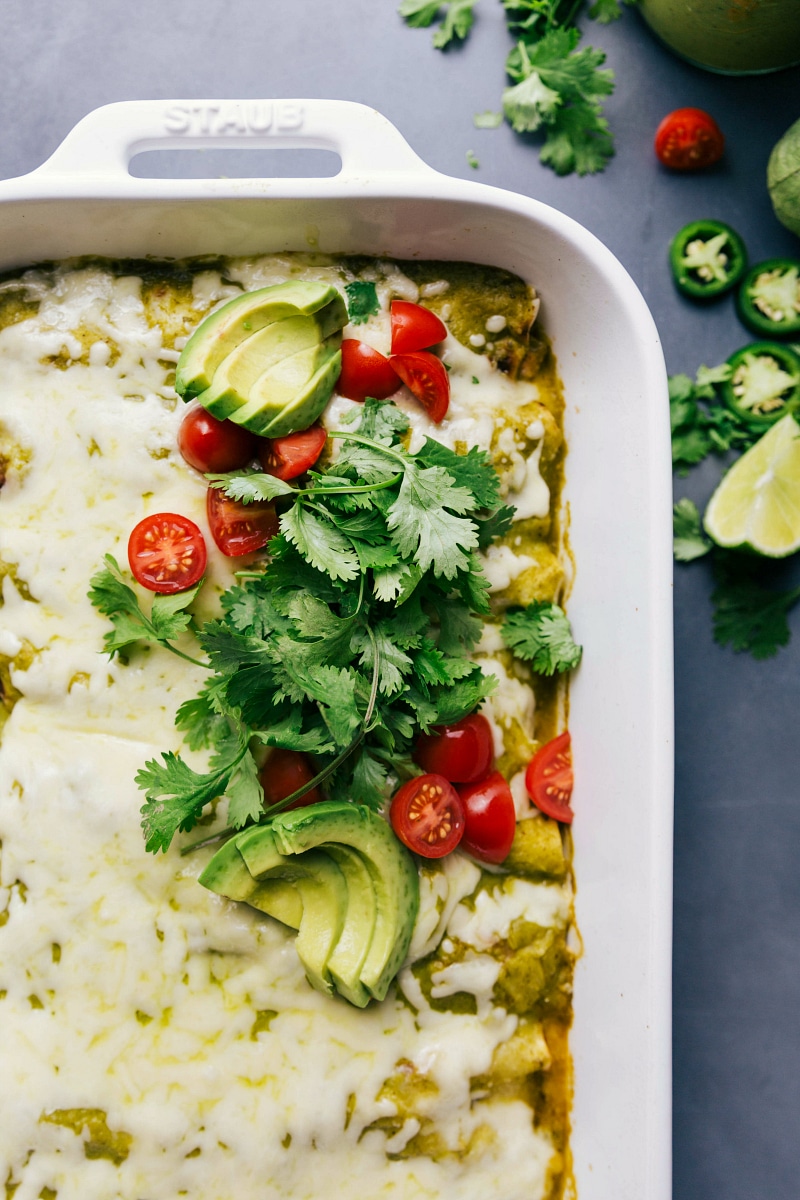 View of the toppings for Green Chile Chicken Enchiladas: cilantro, tomatoes and avocado.